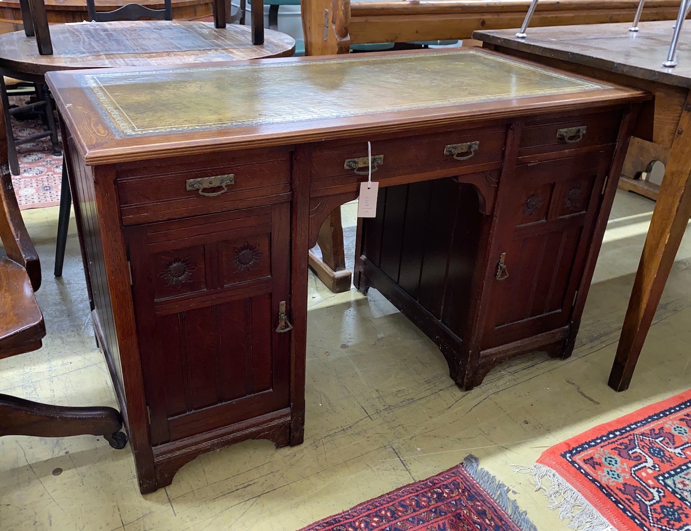 A late Victorian Aesthetic movement oak kneehole writing table, width 120cm, depth 60cm, height 74cm